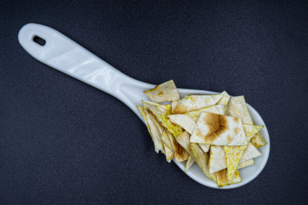 Many delicious potato chips on grocery market counter, tasty food consisting of fresh raw potato...