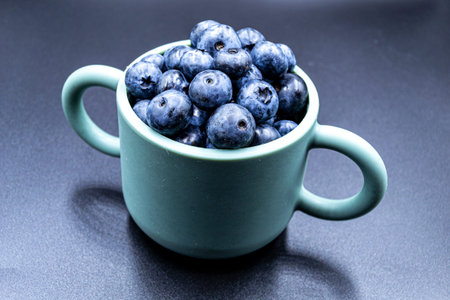 Many delicious summer blueberries on grocery market counter, tasty organic food consisting of fresh...