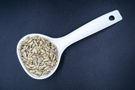 Sunflower seeds on a blue background, beautiful texture ripe of natural sunflower seeds