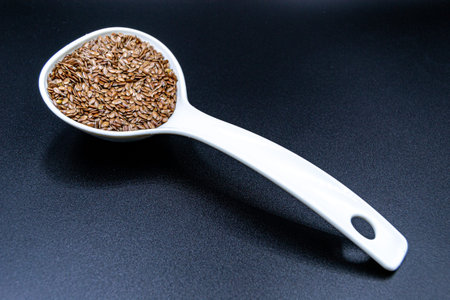 Many delicious summer flax seeds on grocery market counter, tasty organic food consisting of fresh...
