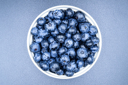 Many delicious summer blueberries on grocery market counter, tasty organic food consisting of fresh...