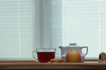 tea set with apples on the background of blindsの写真素材