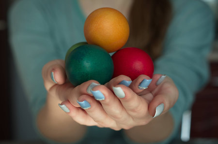 painted eggs in the handsの写真素材