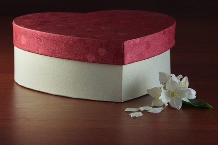 Jasmine and gift box on dark wooden tableの写真素材