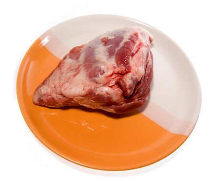 Crude meat laying on a dishの写真素材