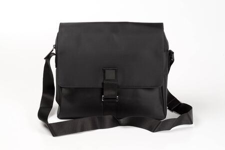 Black shoulder bag over a white backgroundの写真素材