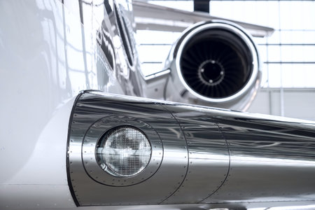 Luxury private jet plane storage inside the hangar. Natural black and white high contrast.