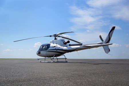 A luxury small helicopter standing on the airport apron, ready to take offの写真素材