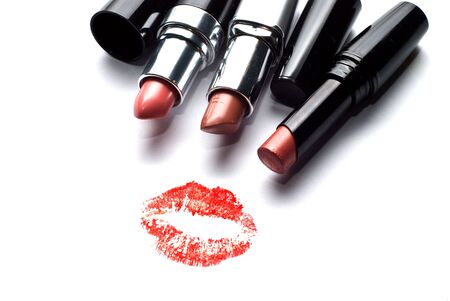 three lipsticks and a kiss on a white backgroundの写真素材