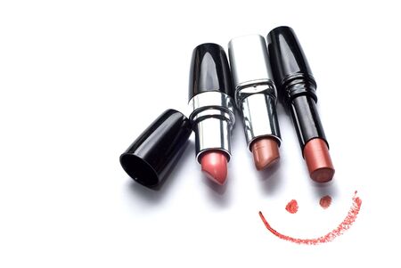 three lipsticks and smile on a white backgroundの写真素材