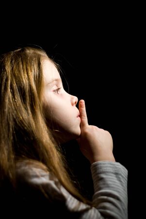 little girl in the darkness requests silenceの写真素材