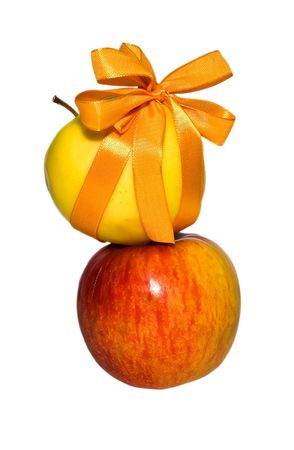 couple of red and yellow apples with a gift bow on a white backgroundの写真素材