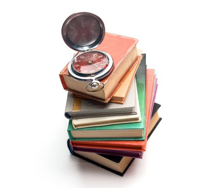 pocket watch on a pile of booksの写真素材