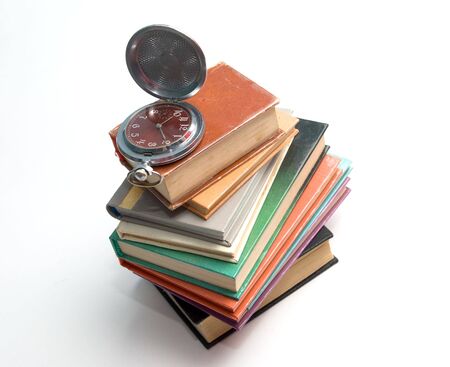 pocket watch on a pile of booksの写真素材