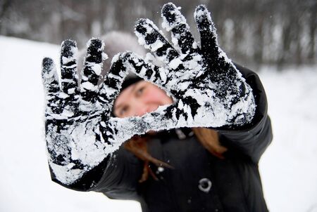 young woman in a winter clothing in a winter woodsの写真素材