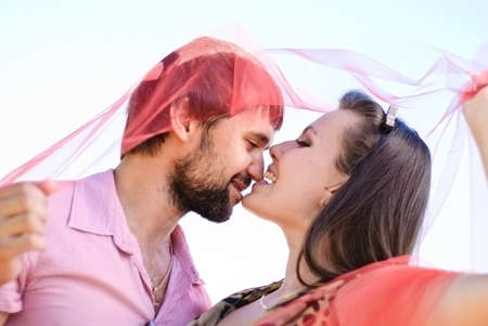 Young happy couple on the field. Shoot on the nature.の写真素材