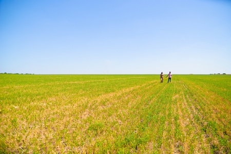 Young happy couple on the field. Shoot on the nature.の写真素材