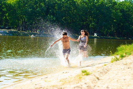 Young happy couple on the beach. Shoot on the nature.の写真素材