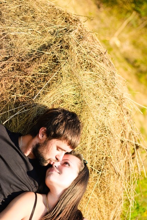 Young happy couple on the field. Shoot on the nature.の写真素材