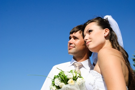 bride and groom and blue sky on the backgroundの写真素材