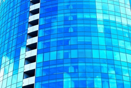 Reflection of the sky and clouds in the windows of a skyscraper