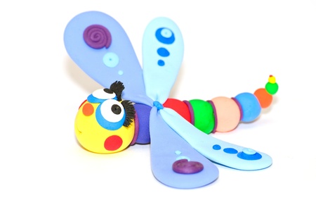 Handmade Plasticine Dragonfly over white