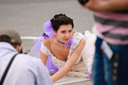 DONETSK, UKRAINE - MAY 15: Annual wedding parade. Bride parade participants in wedding gowns poses during the "Bride Parade" in Donetsk - May 15, 2011 in Donetsk, Ukraine.のeditorial素材