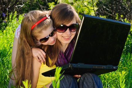 Smiling young mother with little daughter. Sunny summer day.の写真素材