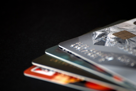 A pile of credit cards with chip on a black background. Close up view.の写真素材