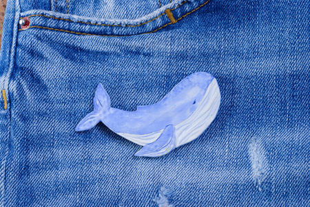 Whale made of clay on a jeans background, Handmade arts and crafts project.の写真素材