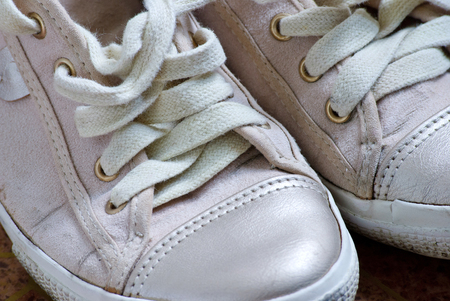 Old dirty white sneakers. Close up view.の写真素材