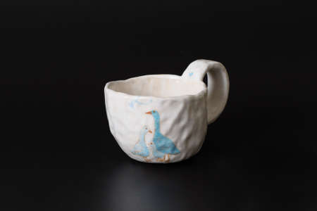 Photography of the authentic handmade ceramic craft ware on a black background. Cup.の写真素材