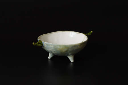 Photography of the authentic handmade ceramic craft ware on a black background. Bowl.の写真素材