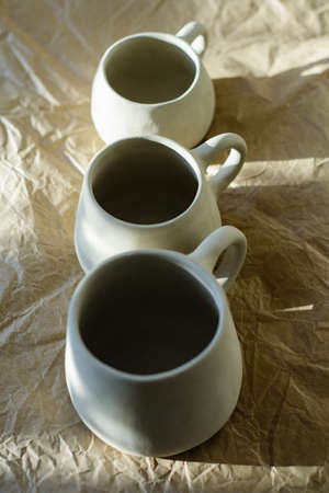 Photography of the authentic handmade ceramic craftware in a cozy home interior. Cups.の写真素材