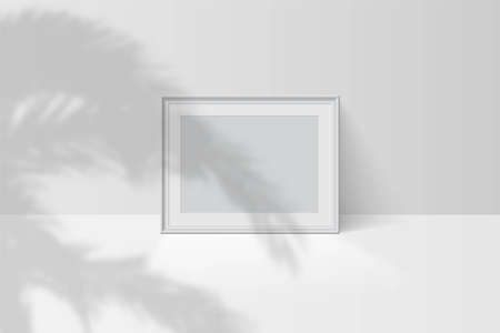 Tropical palm leaf shadow falls on blank horizontal white picture frameのイラスト素材