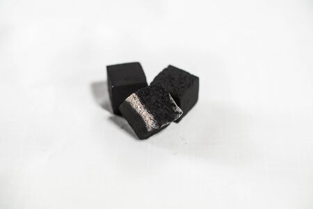 Coal for a hookah smolders on a whiteの写真素材