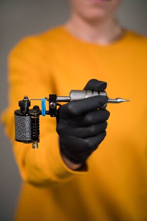 girl in hands tattoo machine permanent tattooの写真素材