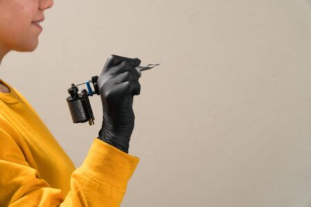 girls in hands black tattoo machine permanentの写真素材