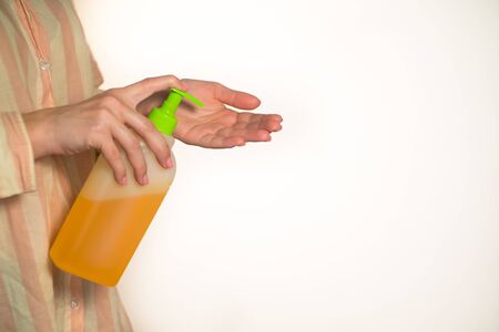 close-up girl squeezes soap and washes her handsの写真素材