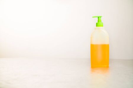 antibacterial soap stands on a light table on a white backgroundの写真素材