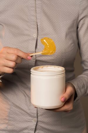 female hands spatula sugar paste close-up vertical photoの写真素材