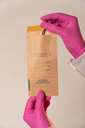 Kraft paper bag to clean tweezers close-up vertical