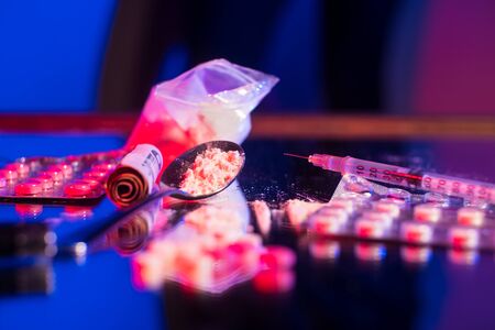many different medicines are on the mirror table. The concept of combating youth dissatisfaction.の写真素材