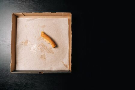 The crust are leftovers from the pizza in the box. The concept of finishing a meal. Fast food delivery.の写真素材