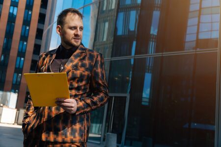 Portrait of a beautiful Caucasian male bineman in a business suit against a dark background. Text writing space.の写真素材