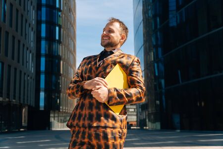 Smiling young man rejoices that he was accepted to the post. Concept to get a job.の写真素材