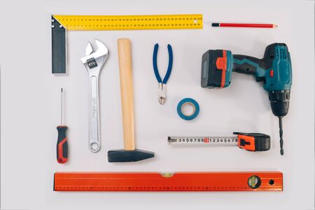 Construction tools on a light background. The concept of using tools to make repairs in an apartment, isolation on a white backgroundの写真素材