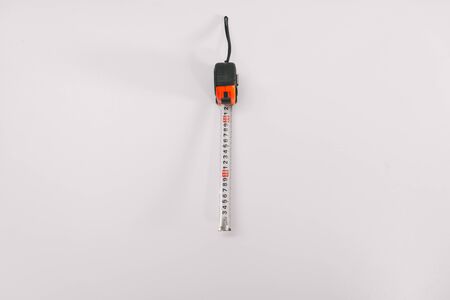 tape measure tape on a white background isolation. Copy space on top. Construction Tools Sale Concept.の写真素材