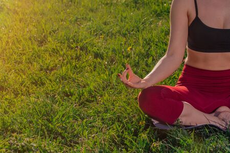 Hands closeup namaste. young Caucasian girl practices yoga meditation in the fresh air. The concept of peace of mind. Balance and harmony in lifeの写真素材