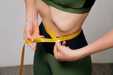 The girl is sick with anorexia. Closeup of female ribs in a thin ugly female body, bulging ribs.の写真素材